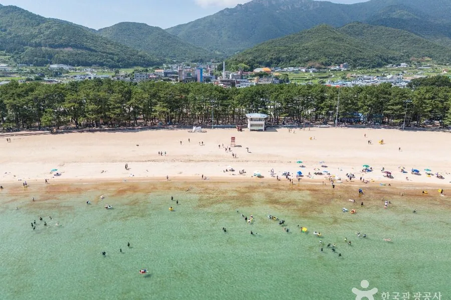 해변 뒤로 솟은 금산 산세. 금산탐방지원센터는 이 해수욕장에서 차로 3분