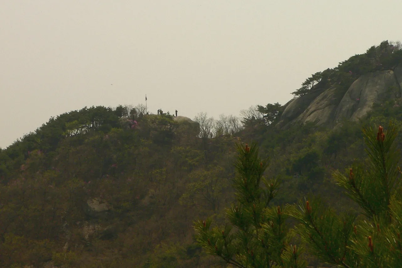 Hikers standing on a rock outcrop on Bukhansan in spring