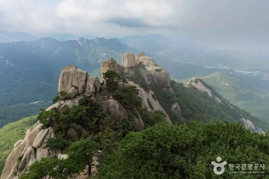 Granite peaks on a Bukhansan ridge with the hazy Seoul basin behind