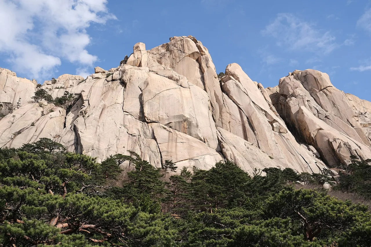 Granite walls of Ulsanbawi Rock with pines below